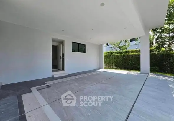 Spacious modern carport with sleek design and lush greenery