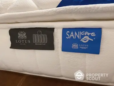 High-quality mattress with Lotus and SANicare labels for luxurious bedroom comfort.