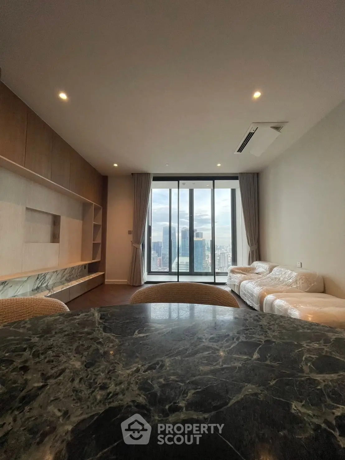 Luxurious living room with stunning city view and elegant marble table