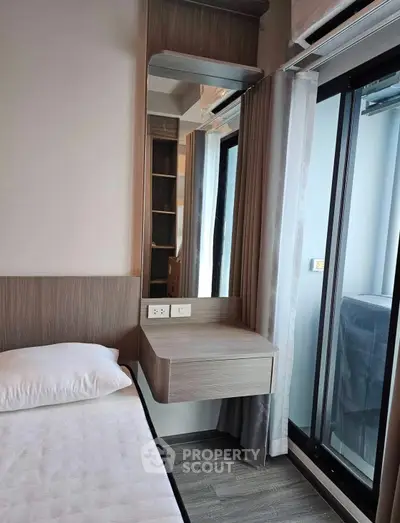 Modern bedroom with sleek design and large window for natural light