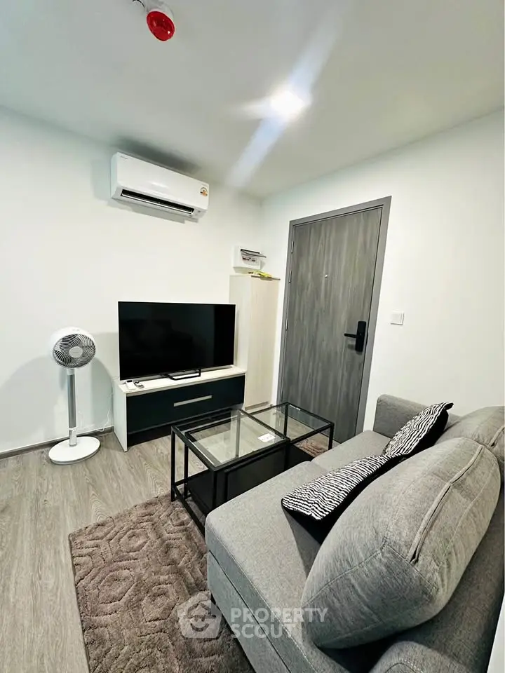 Modern living room with sleek furniture and air conditioning in a cozy apartment.