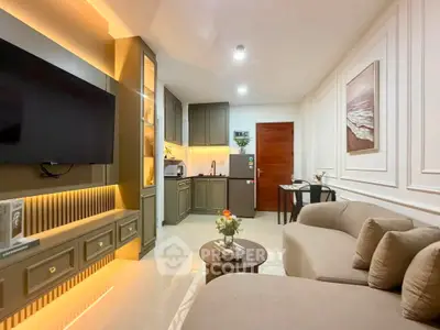 Modern living room with stylish decor and open kitchen layout, featuring elegant lighting and cozy seating.