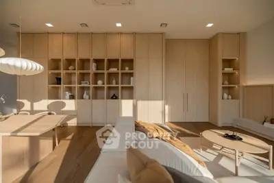 Modern living room with elegant wooden cabinetry and stylish decor