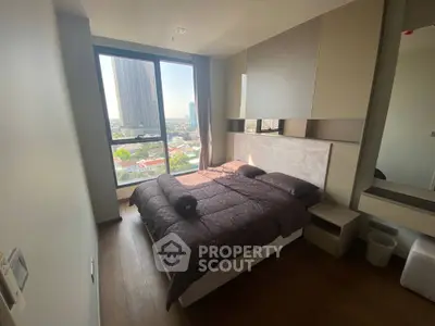 Modern bedroom with city view, featuring sleek design and ample natural light.