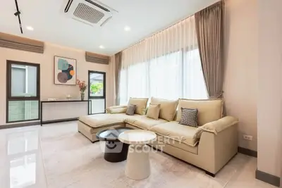 Spacious modern living room with elegant decor and large windows for natural light.