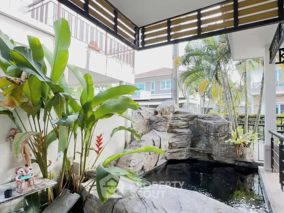 Charming garden with a serene rock pool and lush tropical plants, perfect for relaxation and outdoor enjoyment.