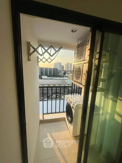 Charming balcony with laundry area and city view, perfect for urban living convenience.