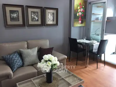 Stylish living room with elegant decor and open kitchen layout, perfect for modern living.