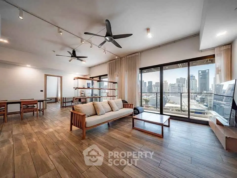 Spacious modern living room with city view and elegant wooden flooring
