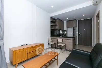 Modern living room with open kitchen and stylish furniture