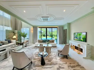 Luxurious living room with elegant decor and large windows overlooking a serene garden view.