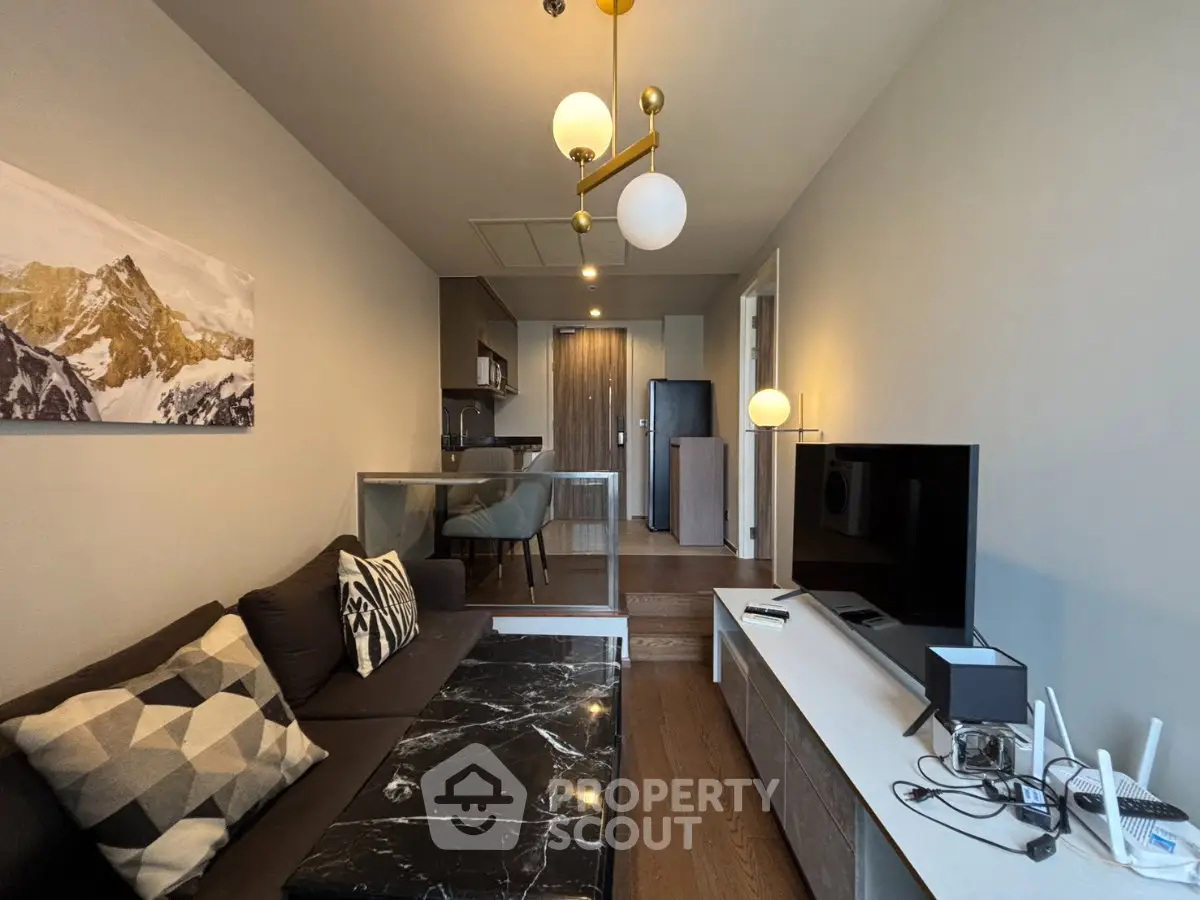 Modern living room with stylish decor and open kitchen layout in a contemporary apartment.