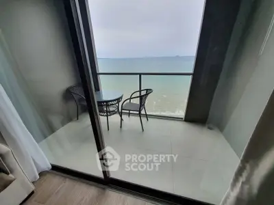 Stunning oceanfront balcony with breathtaking sea view and cozy seating area.