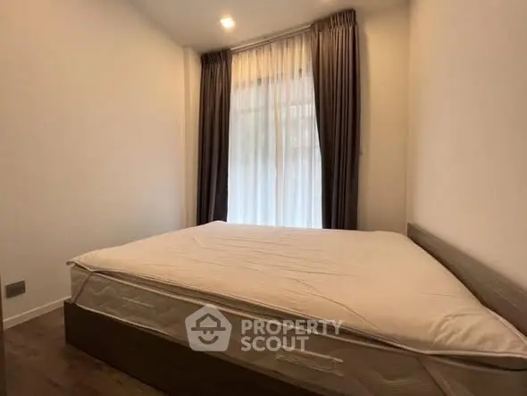 Cozy bedroom with large bed and elegant curtains, perfect for relaxation.