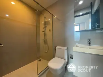 Modern bathroom with glass shower and sleek fixtures