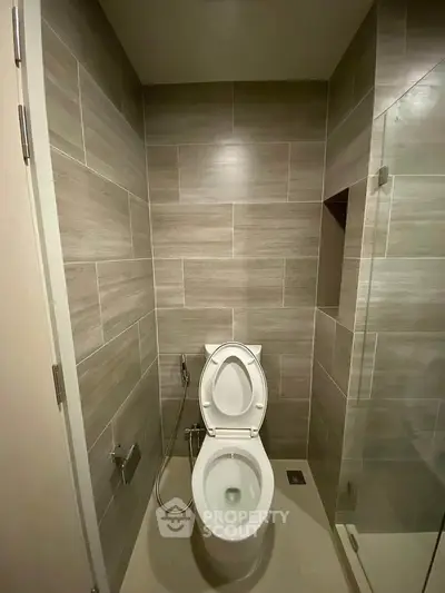 Modern bathroom with sleek tiles and glass shower enclosure