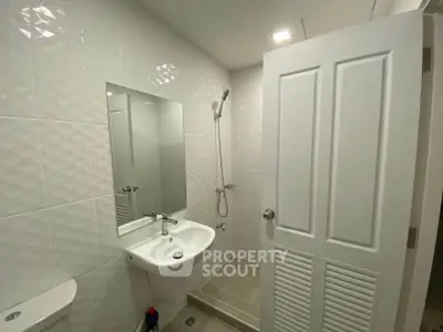 Modern bathroom with sleek white tiles and contemporary fixtures