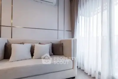 Elegant living room with modern sofa and sheer curtains