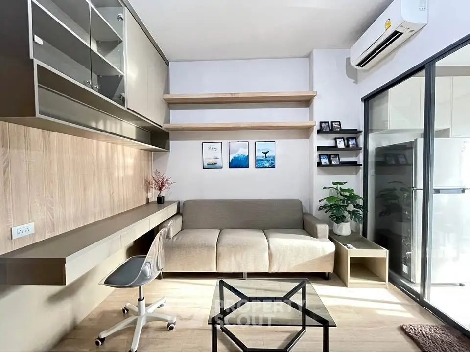 Modern living room with sleek furniture and natural light, featuring a cozy sofa and stylish decor.