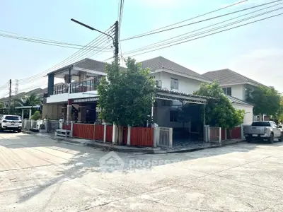 Spacious two-story house with modern design and lush greenery in a serene neighborhood.