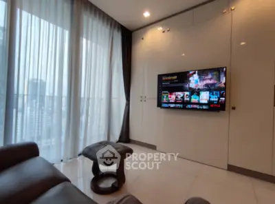 Modern living room with sleek design and city view, featuring a wall-mounted TV and luxurious seating.