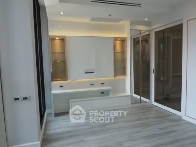 Modern living room with sleek built-in shelving and elegant lighting