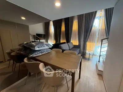 Modern duplex living room with stylish furniture and large windows