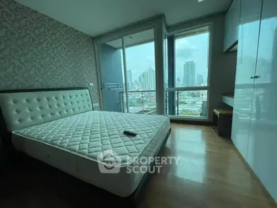 Spacious bedroom with city view and modern decor