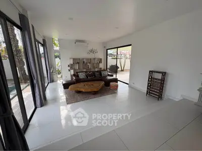 Spacious modern living room with large windows and stylish furniture