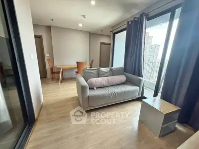 Modern living room with balcony view in high-rise apartment