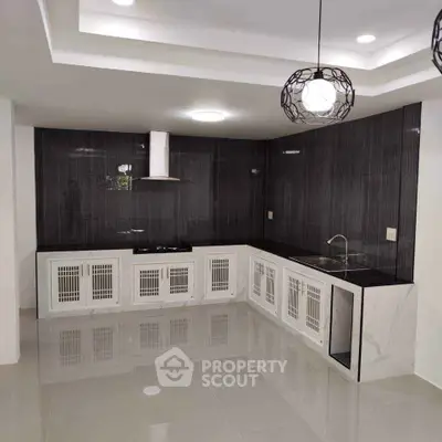 Modern kitchen with sleek black backsplash and white cabinetry