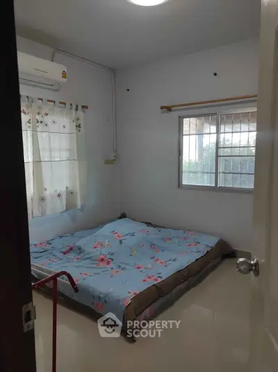 Cozy bedroom with floral bedding and natural light