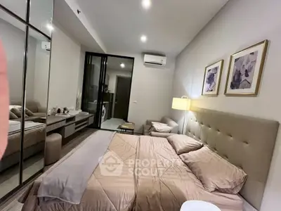 Luxurious bedroom with modern decor and cozy ambiance, featuring elegant lighting and stylish artwork.