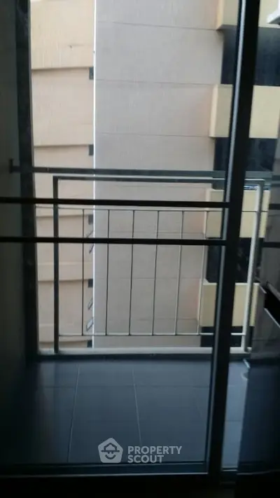 Modern apartment balcony with sleek railing and urban view