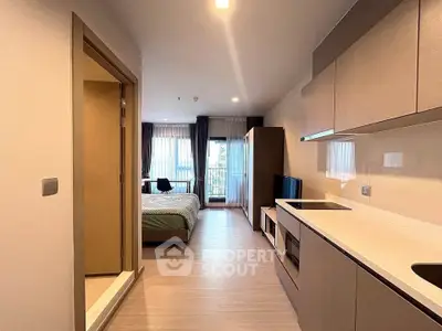 Modern studio apartment with open kitchen and cozy bedroom area