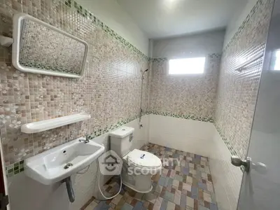 Spacious bathroom with modern fixtures and mosaic tile design
