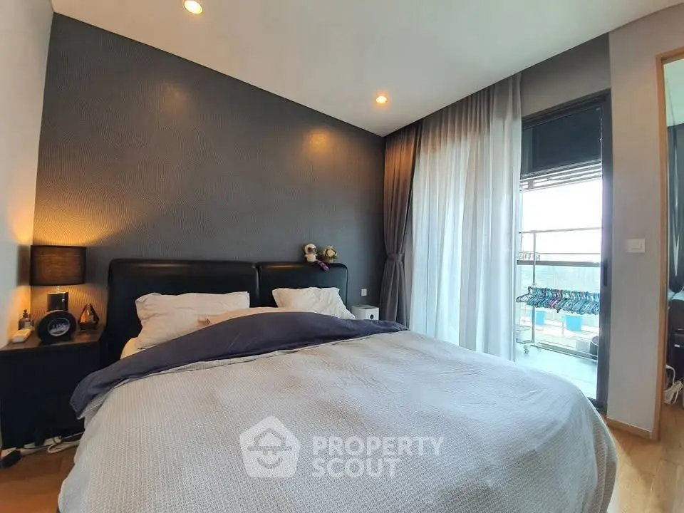 Modern bedroom with cozy ambiance and balcony view