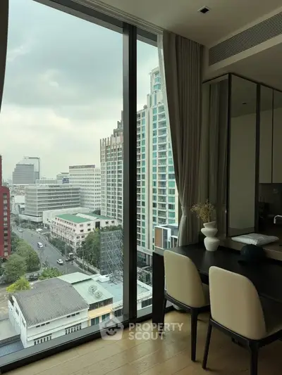 Modern high-rise apartment with stunning city view from large window, featuring elegant dining area.