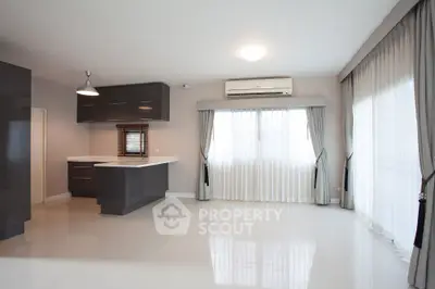 Spacious modern living room with open kitchen and large windows