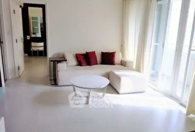 Bright living room with modern sofa and natural light from large windows.