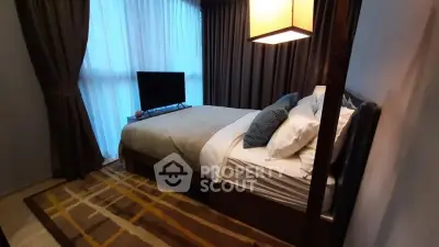 Cozy bedroom with modern decor and large window for natural light