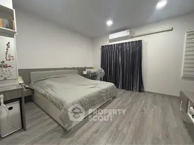 Spacious modern bedroom with sleek design and cozy ambiance