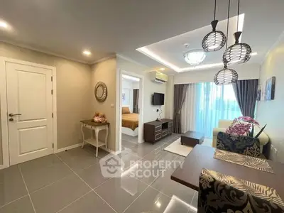 Modern living room with elegant decor and open layout, featuring stylish lighting and a cozy ambiance.