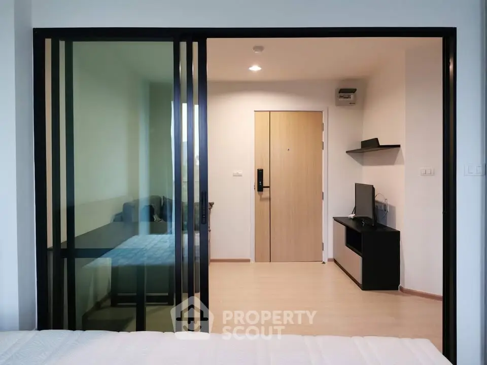 Modern apartment interior with sliding glass doors and minimalist decor