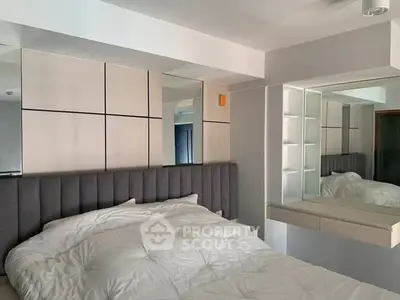 Modern bedroom with stylish decor and plush bedding