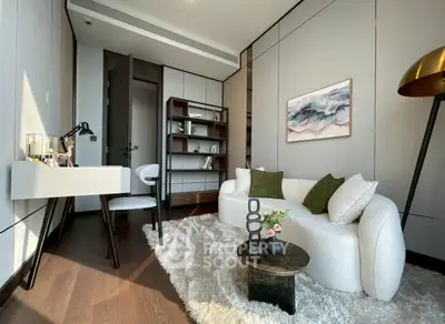 Modern living room with stylish furniture and elegant decor, featuring a cozy sofa and chic shelving unit.