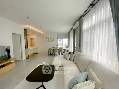 Spacious modern living room with elegant decor and large windows