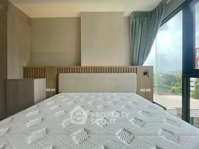 Modern bedroom with large window and stylish decor