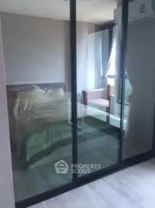 Modern bedroom with glass sliding doors and natural light