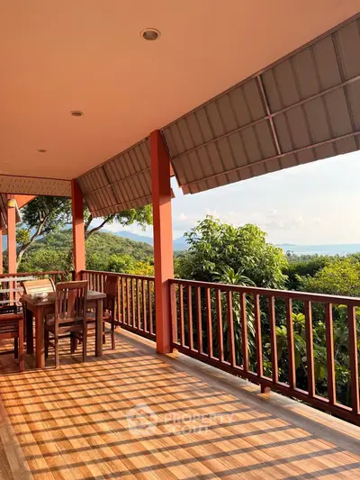 Stunning balcony with panoramic views and elegant wooden furniture, perfect for relaxation and enjoying nature.